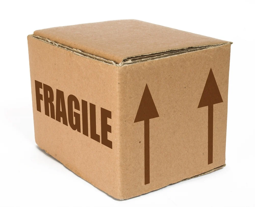 cardboard box with the word fragile on it and arrows pointing up